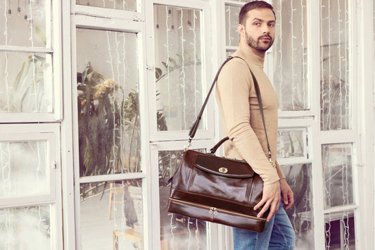 a young man carrying a brown leather doctor bag on his shoulder 